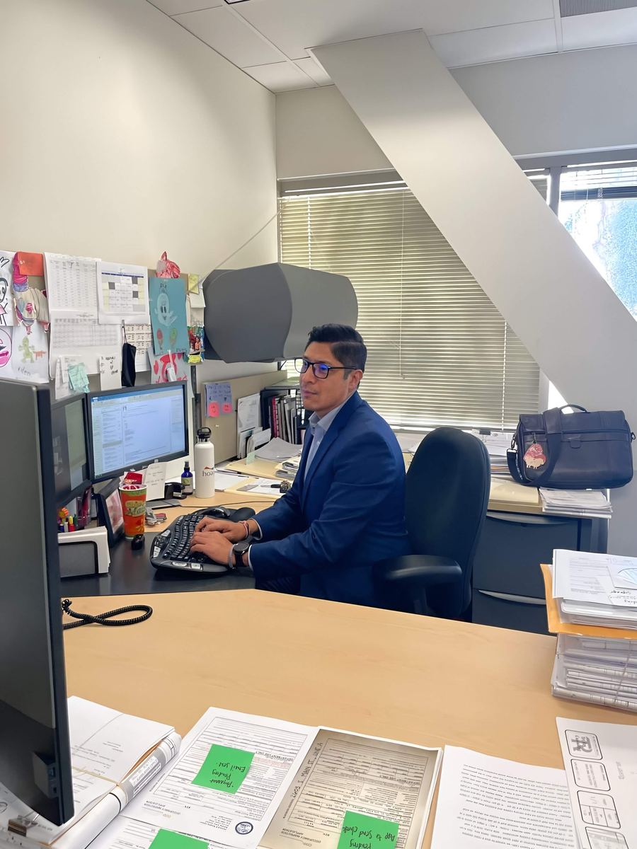 Mario Espindola working at his desk during his municipal HR career